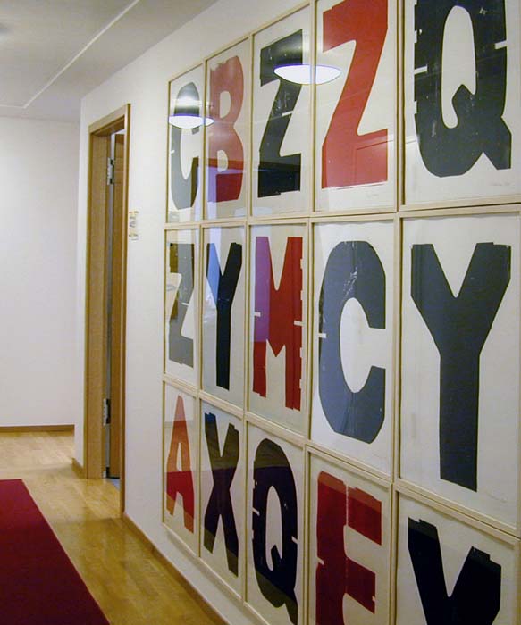 large woodcut letters each printed red or black, wall mounted in a private collection