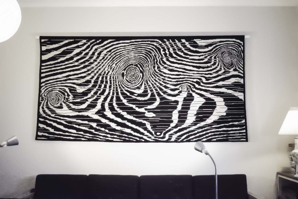 The unfolded wool drapery on the track, flat on the wall, almost filling image, 
some furniture on the edges