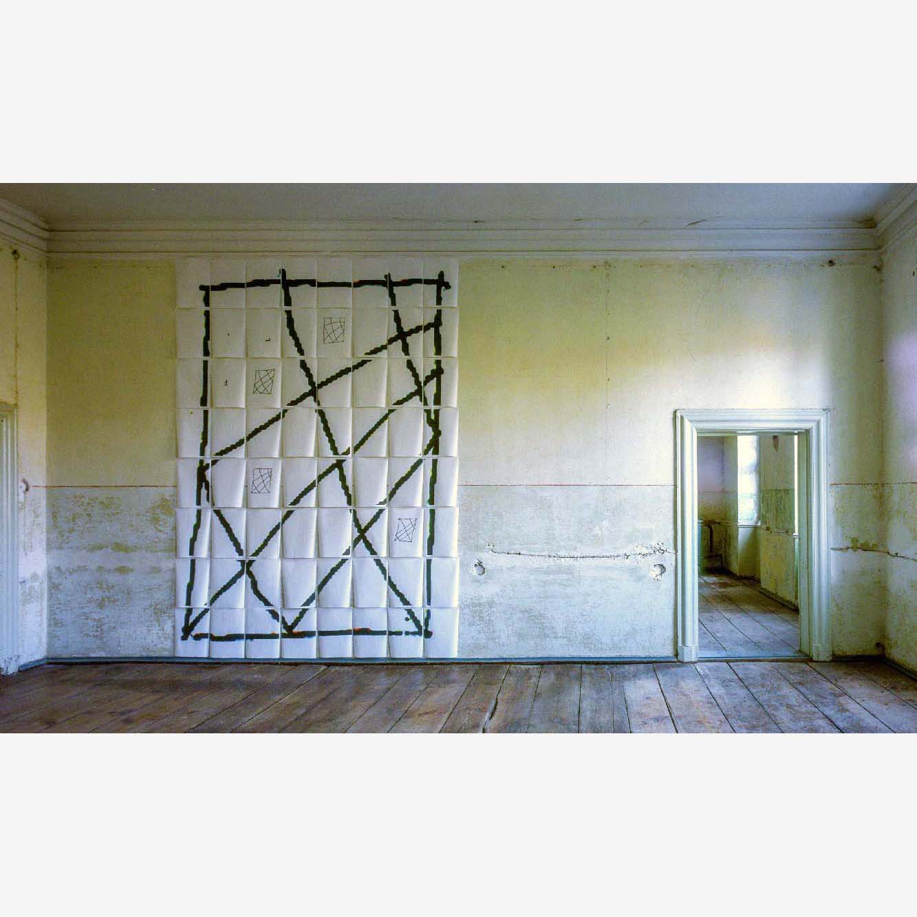 In one large empty room, a geometric grid drawing fills the wall, flooded in daylight 
through an unseen window right