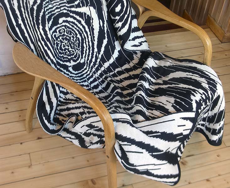 digital knitwear throw laying in chair